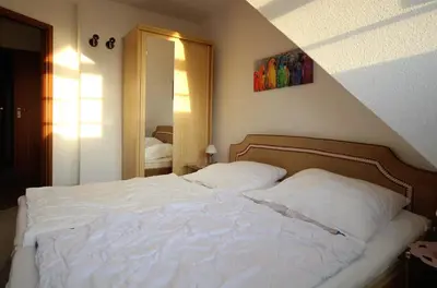 Ein Bett oder Betten in einem Zimmer der Unterkunft Haus Elbe 1, Whg 38