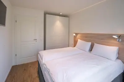 Ein Bett oder Betten in einem Zimmer der Unterkunft Haus Lütt Schick Apartment Feenja