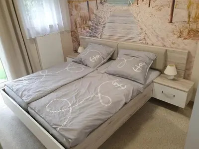 Ein Bett oder Betten in einem Zimmer der Unterkunft Strandstraße 51a, FeWo Marina
