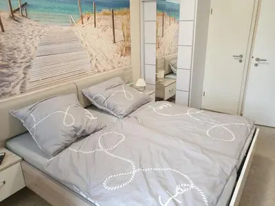Ein Bett oder Betten in einem Zimmer der Unterkunft Strandstraße 51a, FeWo Marina
