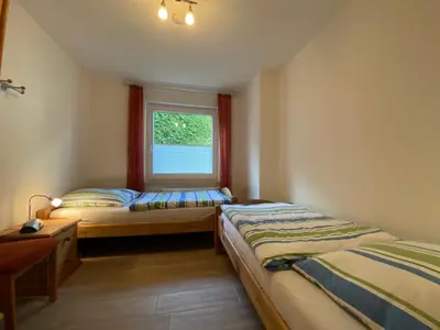 Ein Bett oder Betten in einem Zimmer der Unterkunft Dünenwind, Ferienwohnung 1