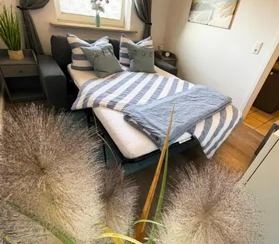 Ein Bett oder Betten in einem Zimmer der Unterkunft Ferienwohnung „Deichgeflüster“ nahe der Nordsee