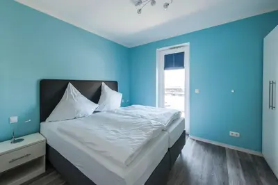 Ein Bett oder Betten in einem Zimmer der Unterkunft Haus Deichkieker Apartment 4 2 Watt n Meer