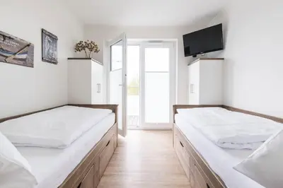 Ein Bett oder Betten in einem Zimmer der Unterkunft Haus Deichkieker Apartment 4 3 Deichgut