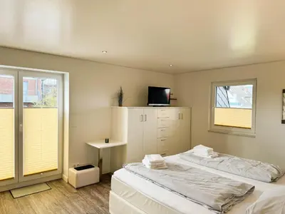 Ein Bett oder Betten in einem Zimmer der Unterkunft Sand & Meer Penthouse-Apartment 5