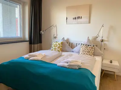 Ein Bett oder Betten in einem Zimmer der Unterkunft Haus Strandläufer Apartment 3 2 Strandhaus 3 2