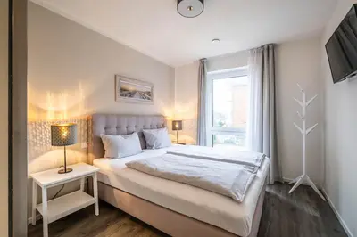 Ein Bett oder Betten in einem Zimmer der Unterkunft Haus Strandläufer Apartment 1 1 Meeresrauschen
