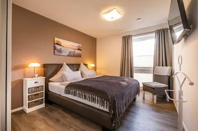 Ein Bett oder Betten in einem Zimmer der Unterkunft Haus Strandläufer Apartment 1 7 Strand-Idylle