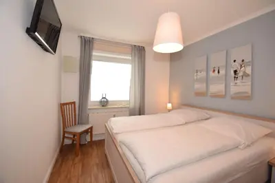 Ein Bett oder Betten in einem Zimmer der Unterkunft Haus Seemeile Wohnung 2 19