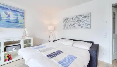 Ein Bett oder Betten in einem Zimmer der Unterkunft Haus Deichkieker Apartment 2 5 Strandperle