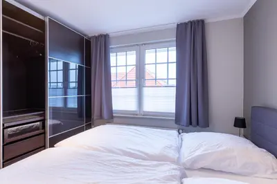 Ein Bett oder Betten in einem Zimmer der Unterkunft Fischerhus, Zum weißen Kliff