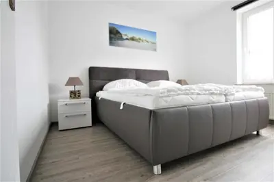 Ein Bett oder Betten in einem Zimmer der Unterkunft Residenz Kormoran 1 0