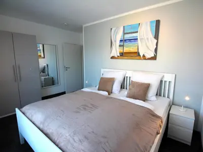 Ein Bett oder Betten in einem Zimmer der Unterkunft Residenz Helmsand