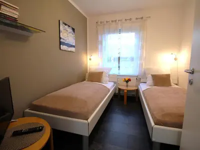 Ein Bett oder Betten in einem Zimmer der Unterkunft Residenz Helmsand