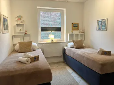 Ein Bett oder Betten in einem Zimmer der Unterkunft Residenz Vogelsand 2