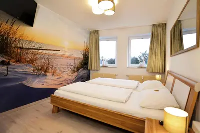 Ein Bett oder Betten in einem Zimmer der Unterkunft Haus Nordseebrandung NB44