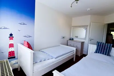 Ein Bett oder Betten in einem Zimmer der Unterkunft Haus Nordseebrandung NB45