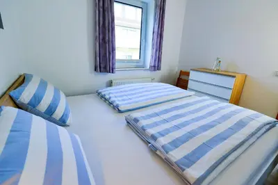 Ein Bett oder Betten in einem Zimmer der Unterkunft Haus Seewind HS01