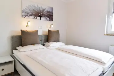 Ein Bett oder Betten in einem Zimmer der Unterkunft Strandhochhaus SA10