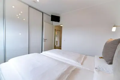Ein Bett oder Betten in einem Zimmer der Unterkunft Strandhochhaus SA10