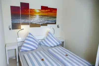 Ein Bett oder Betten in einem Zimmer der Unterkunft Strandhochhaus SB10