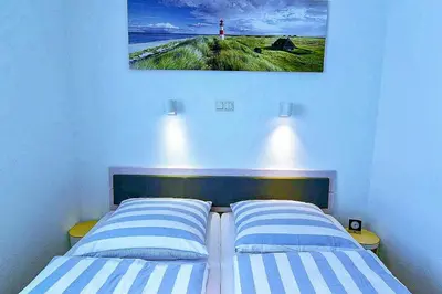 Ein Bett oder Betten in einem Zimmer der Unterkunft Strandhochhaus SD09