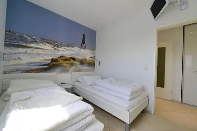 Ein Bett oder Betten in einem Zimmer der Unterkunft Strandhochhaus SD11