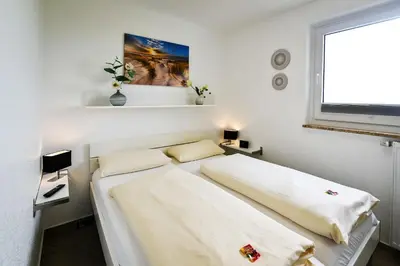 Ein Bett oder Betten in einem Zimmer der Unterkunft Strandhochhaus SF10