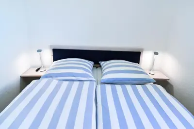Ein Bett oder Betten in einem Zimmer der Unterkunft Strandhochhaus SF11