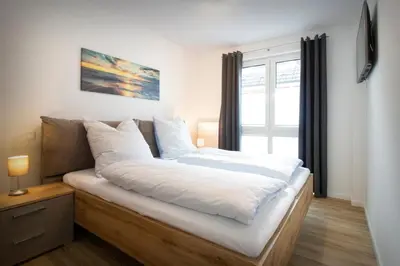 Ein Bett oder Betten in einem Zimmer der Unterkunft Dünenquartier Cuxhaven
