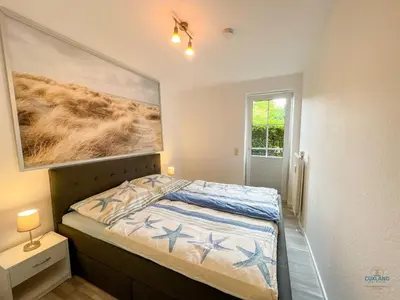Ein Bett oder Betten in einem Zimmer der Unterkunft Haus Elbstrom Döse Whg 11