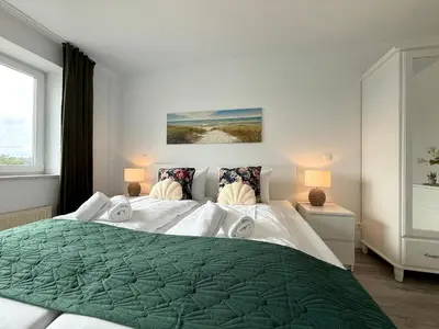 Ein Bett oder Betten in einem Zimmer der Unterkunft Nordseebrandung A2 1