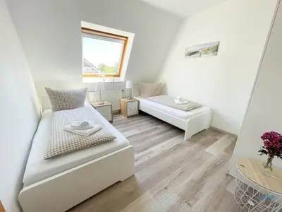 Ein Bett oder Betten in einem Zimmer der Unterkunft Residenz Grantz Sahlenburg Wohnung 1