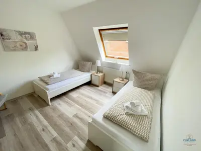 Ein Bett oder Betten in einem Zimmer der Unterkunft Residenz Grantz Sahlenburg Wohnung 3