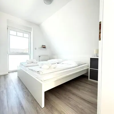 Ein Bett oder Betten in einem Zimmer der Unterkunft Ringwall 80b