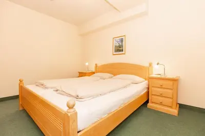 Ein Bett oder Betten in einem Zimmer der Unterkunft Kurpark-Residenz 215