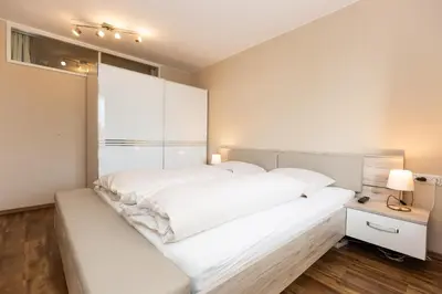 Ein Bett oder Betten in einem Zimmer der Unterkunft Kurpark-Residenz 202