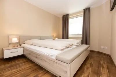 Ein Bett oder Betten in einem Zimmer der Unterkunft Kurpark-Residenz 202