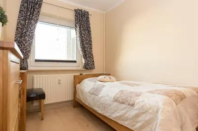 Ein Bett oder Betten in einem Zimmer der Unterkunft Strandhochhaus 5