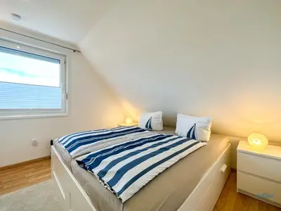 Ein Bett oder Betten in einem Zimmer der Unterkunft Ferienhaus Seepferdchen Duhnen
