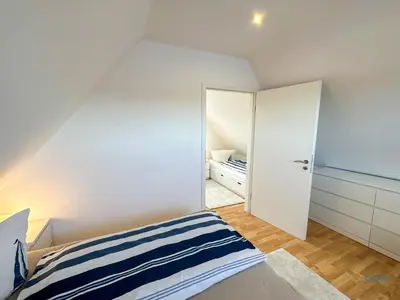 Ein Bett oder Betten in einem Zimmer der Unterkunft Ferienhaus Seepferdchen Duhnen