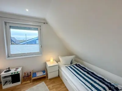 Ein Bett oder Betten in einem Zimmer der Unterkunft Ferienhaus Seepferdchen Duhnen
