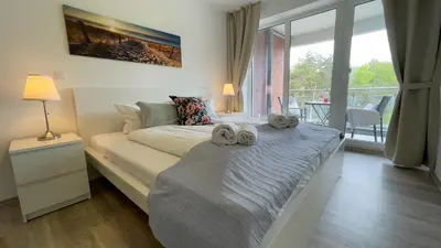 Ein Bett oder Betten in einem Zimmer der Unterkunft Nordseebrandung FeWo A4 3