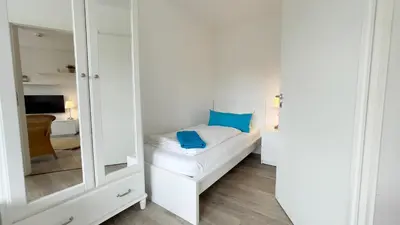 Ein Bett oder Betten in einem Zimmer der Unterkunft Nordseebrandung FeWo A4 3