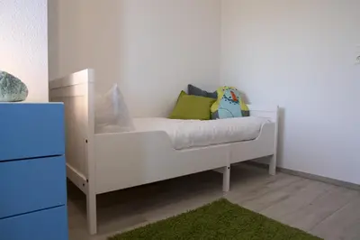 Ein Bett oder Betten in einem Zimmer der Unterkunft Nordseebrandung FeWo B3 4