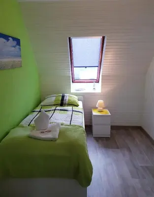 Ein Bett oder Betten in einem Zimmer der Unterkunft Kleine Nixe Dünenblick