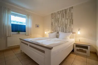 Ein Bett oder Betten in einem Zimmer der Unterkunft Seewärts Wohnen