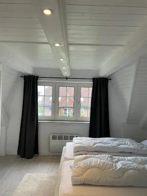 Ein Bett oder Betten in einem Zimmer der Unterkunft Nordseetraum - Ferienhaus Wolke