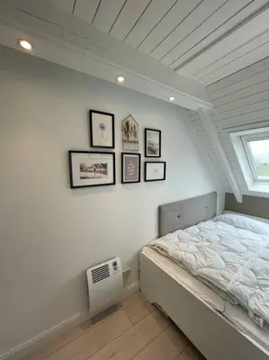 Ein Bett oder Betten in einem Zimmer der Unterkunft Nordseetraum - Ferienhaus Wolke