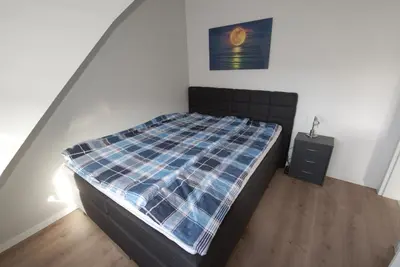 Ein Bett oder Betten in einem Zimmer der Unterkunft Deichläufer